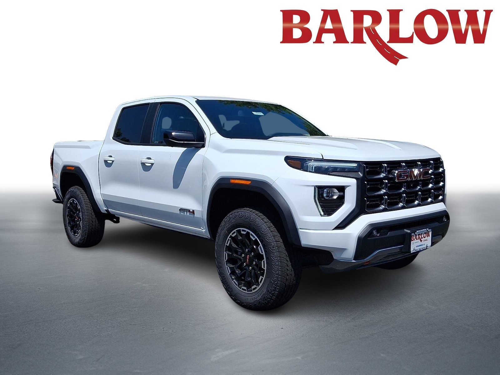 2026 GMC Canyon AT4 in Summit White — front three-quarter view