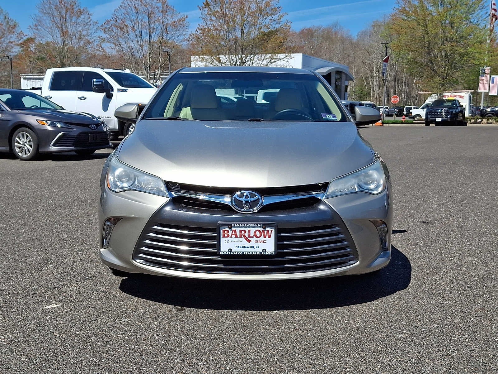 2016 Toyota Camry XLE in Gold — front three-quarter view